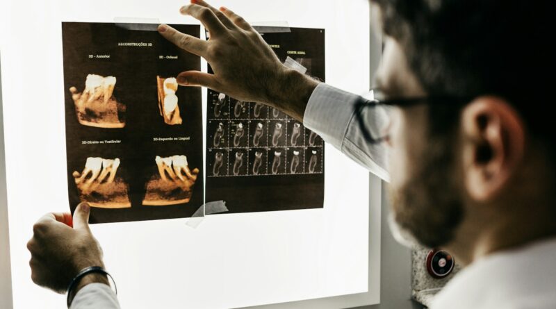 person in gray long sleeve shirt holding black tablet computer